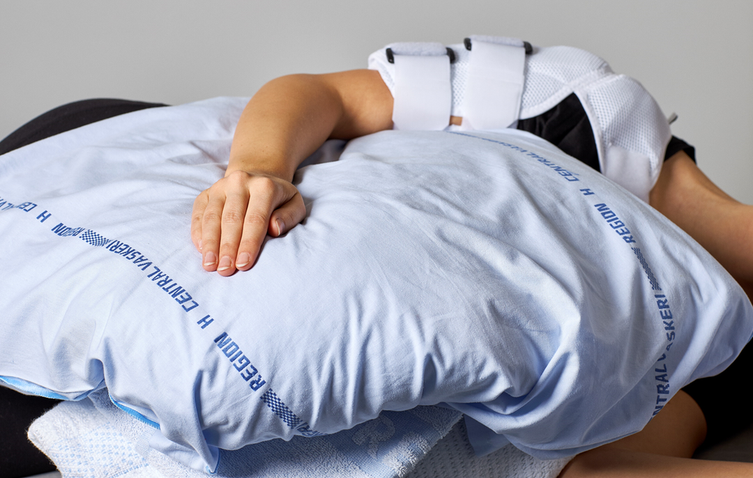 Picture of a person resting their arm on a pillow