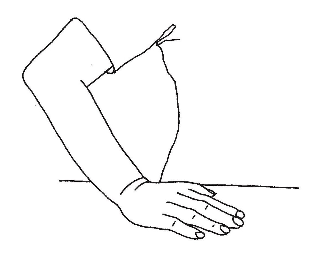 Billedet viser, at underarmen lægges på en bordplade, hvorefter albuen løftes, men håndfladen forbliver på bordet.
