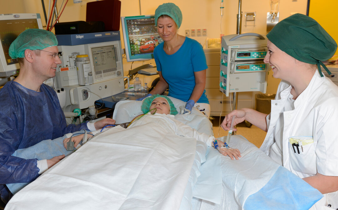 Felix ligger i sengen på operationsstuen, hvor hans far og to sygeplejersker sidder ved siden af.