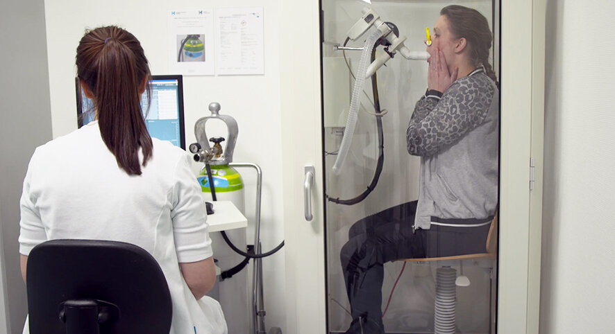The picture shows a woman doing the extended lung function test.