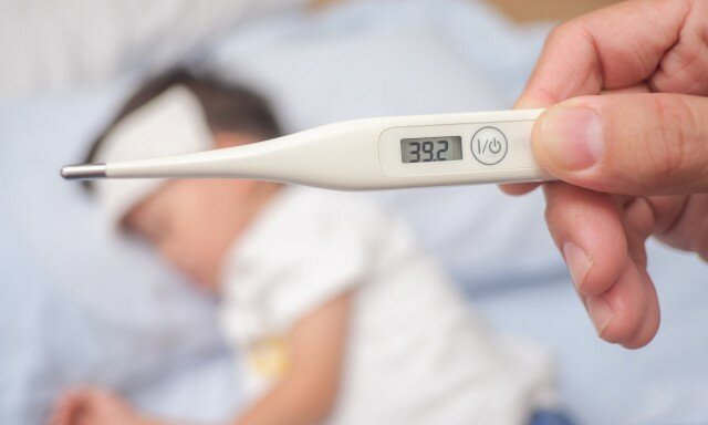 The picture shows a thermometer with a child in the background.